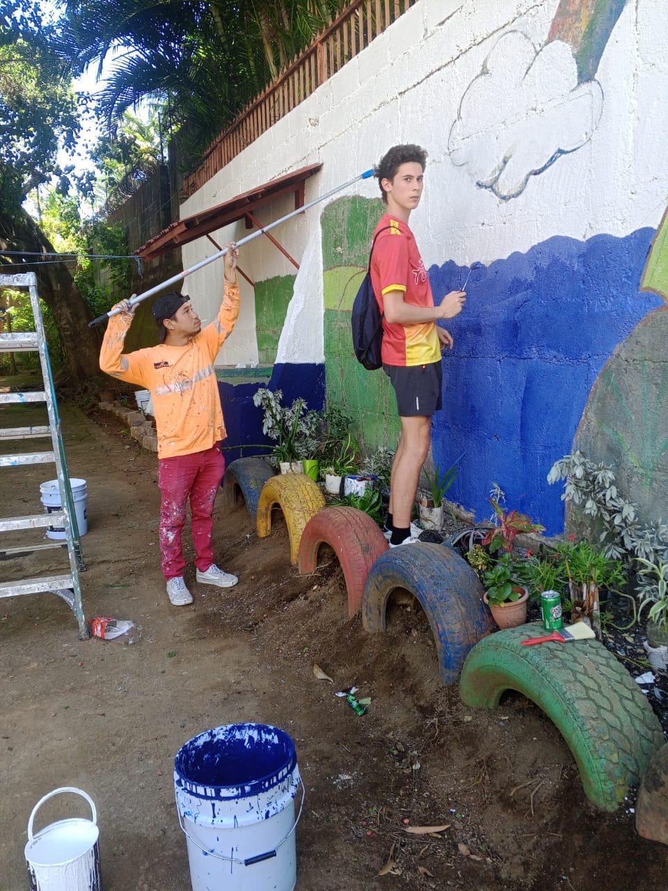 Painting behind-the-scenes work during the Engineers for Hope school transformation